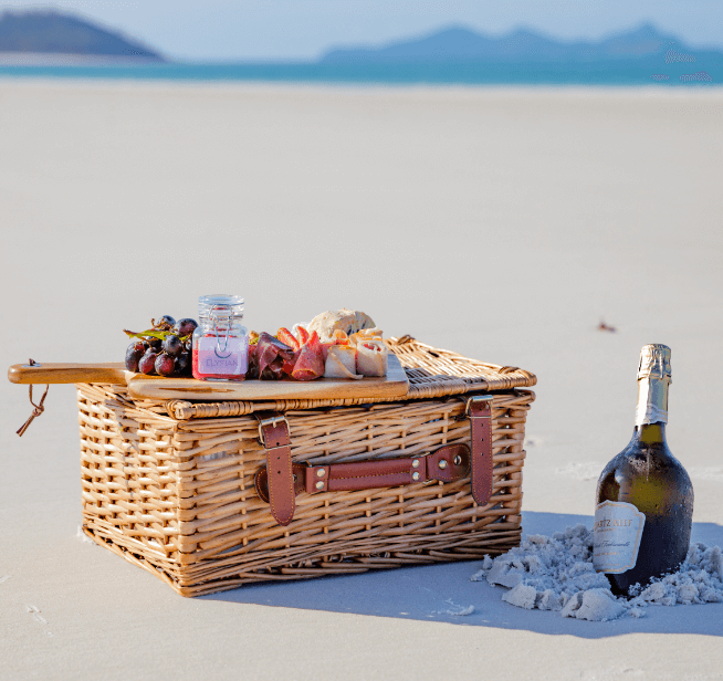 Dreamaroo Luxury, Bottle in the Sand With Picnic Basket, Grapes & Cheeses and View of Beach & Mountains Image